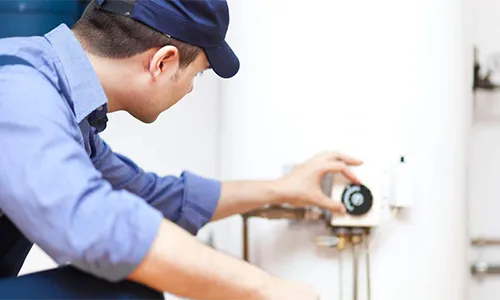 plumber fixing broken hot water heater
