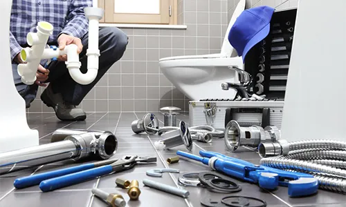 plumber installing new equipment in bathroom